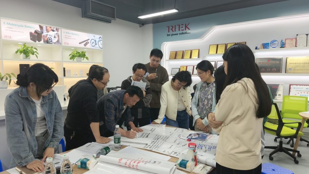 Engineers discussing design risks in battery system development